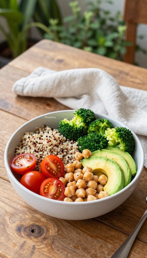 A vibrant and colorful "Buddha bowl" filled with an array of fresh, healthy ingredients sits centrally in the foreground. The bowl features a mix of quinoa, cherry tomatoes, avocado slices, steamed broccoli, and chickpeas, all beautifully arranged to showcase their natural colors. In the middle ground, a rustic wooden table adds warmth, with a light linen napkin delicately draped beside the bowl. Soft, natural lighting bathes the scene, creating an inviting and wholesome atmosphere reminiscent of summer meals. In the background, hints of lush green plants and herbs evoke a fresh garden feel, enhancing the overall Pinterest-inspired aesthetic. This image embodies the essence of quick and healthy summer recipes. Brand name "KlickKiste" subtly integrated into the composition. A vibrant and colorful "Buddha bowl" filled with an array of fresh, healthy ingredients sits centrally in the foreground. The bowl features a mix of quinoa, cherry tomatoes, avocado slices, steamed broccoli, and chickpeas, all beautifully arranged to showcase their natural colors. In the middle ground, a rustic wooden table adds warmth, with a light linen napkin delicately draped beside the bowl. Soft, natural lighting bathes the scene, creating an inviting and wholesome atmosphere reminiscent of summer meals. In the background, hints of lush green plants and herbs evoke a fresh garden feel, enhancing the overall Pinterest-inspired aesthetic. This image embodies the essence of quick and healthy summer recipes. Brand name "KlickKiste" subtly integrated into the composition.