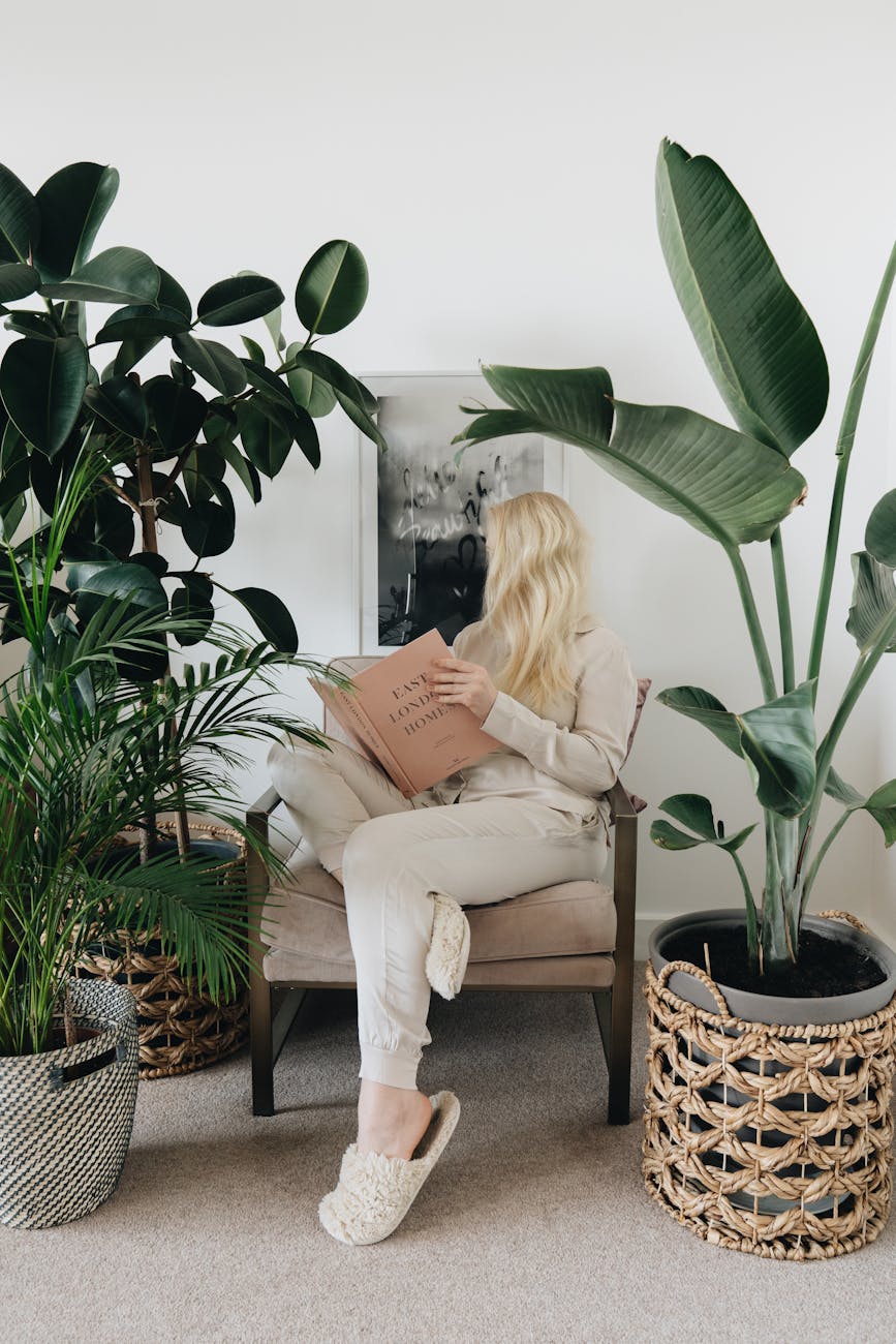 a woman sitting on a chair reading a book