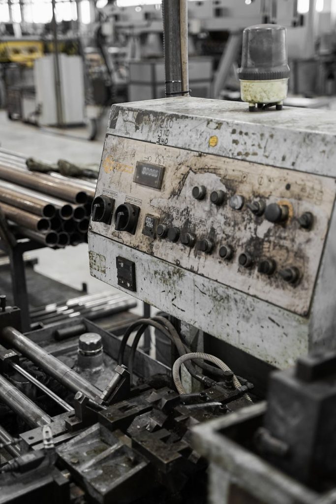 a gray and black industrial machine full of dirt