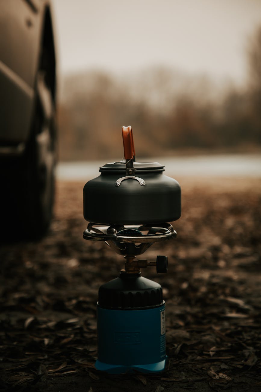 portable camping stove in rustic outdoor setting
